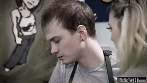 Petite blonde helps customer while she’s rimmed behind counter