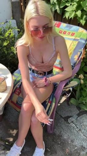 A nice teen is smoking coughing hocking and spitting loogies into a glass
