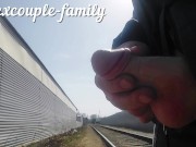 Jerking off and cumming at the railway crossing behind the fence people work