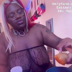 Ebony BBW stuffs her face while she is topless