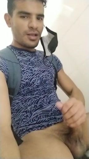 Young gay Latino in bathroom