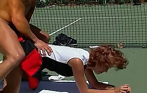 MILF rossa succhia il cazzo attraverso la rete da tennis