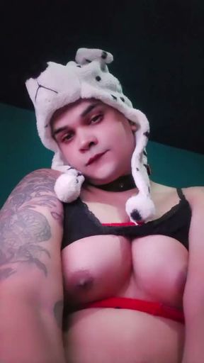 A tranny showing off her large, feminine breasts.