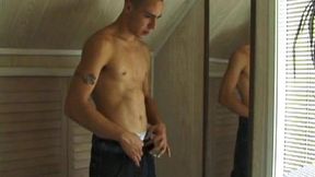 This tattooed hottie wants us to watch him jerk off. Bradley comes in and immediately takes charge of the task at hand. He starts a porn video, lubes up his cock and strokes out a healthy load of cum all over mirror.