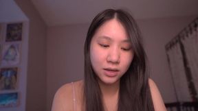 Innocent Asian girl reads scripture while touching herself