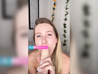 Golden-haired sucks large sex-toy on camera