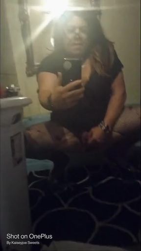 Sexy crossdresser Krissy Sweets in lingerie and high heels with fishnets.