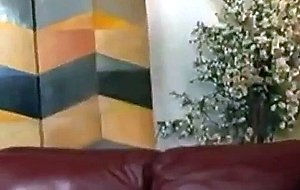Penny flame is sitting on her couch with her boyfr