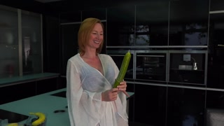 Horny mature Tara pleases her cock hungry pussy using cucumber with condom