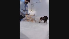 GG87-A white-stockinged Asian girl is bound by wooden shackles.