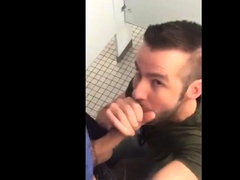 Handsome guy sucks dick in restroom stall