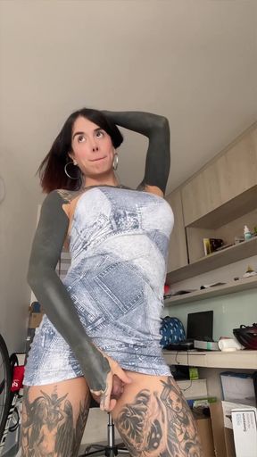 Tattooed woman in fishnet bodysuit