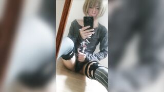 A femboy stroking in front of the mirror