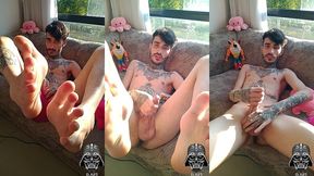 endowed dark-haired man showing off the soles of his feet