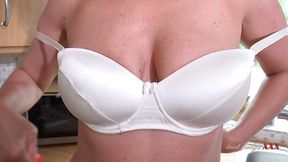 Busty blonde MILF Julia North fingers her pussy in the kitchen