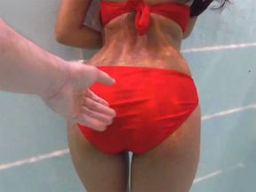 Amateur teen couple foreplay in a public pool and sex