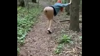 Redheaded beauty RitaFox walks in the woods and shows her privates