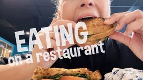 Devouring a sandwich on public