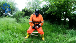 Railing Dino Plaything in Garden Dressed In Hivis and Condom Footwear