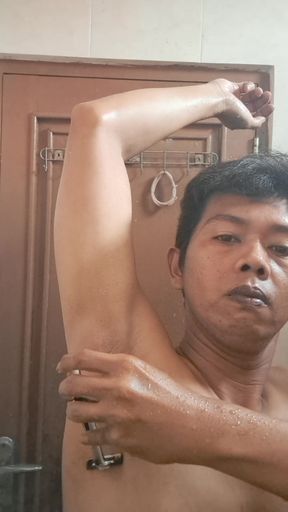 Exotic skinned Asian adult man shaving