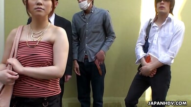 Asian brunette gives a discreet handjob in a crowded subway car