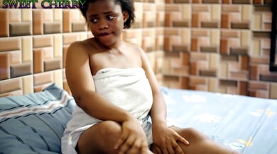 Curvy Black woman fingers her shaved pussy on camera in a voyeuristic solo session