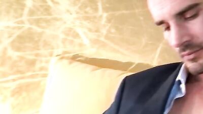 Guy in suit gets a nice handjob from his horny co-worker