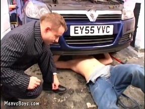 Young Car Mechanic Servicing Older Gay Businessman