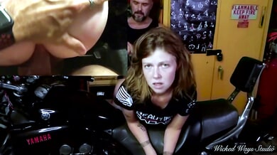 Redhead bends over a motorcycle for rough anal in a messy garage