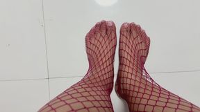 Red fishnet stockings with an Asian model flexing her toes in a top-down soles view