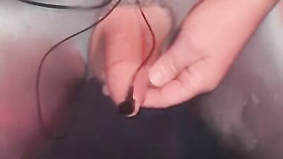 Sissy playing with electric shock penis plug