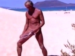 Tanned guy on beach in tiny string thong (temporarily!)