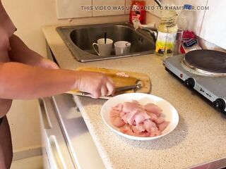 Zara is cooking topless in the kitchen