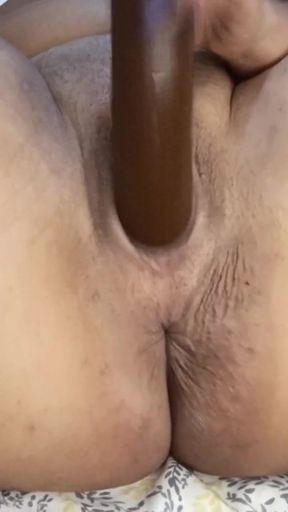A big, wet pussy is penetrated by a black dildo with a diamond plug in her ass.   Clip 2