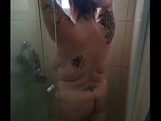 big beautiful woman takes a shower after gym