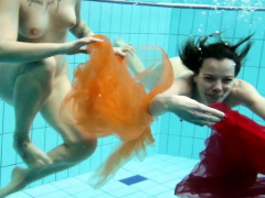 Two hotties submerged underwater