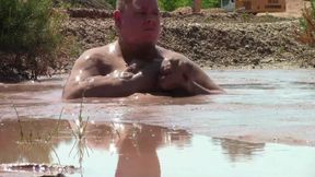 Deep, Creamy Brown Mud Bath in a Sand Pit