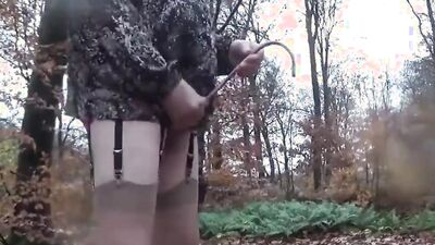 Amateur femboy is playing with his pecker in the forest