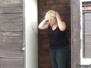 Busty golden-haired grandma rides rod outdoors