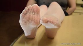 Sexy legs in white fishnet stockings