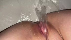 Horny girl pleases herself in shower with a jet of water