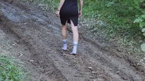 Muddy nylon socks, white socks in a deep mud, wet and muddy white socks, white socks stuck