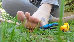 Crushing toy cars with bare feet in the public garden 1080HD