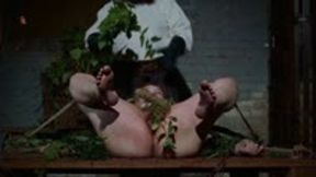 Novice Magda is tied to a wooden bench and treated with nasty stinging nettles