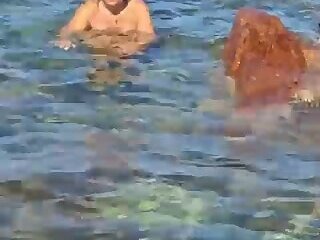 the slut masturbates like a whore in the sea without fear of being seen