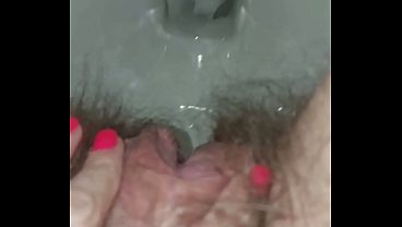 Pissing woman in the toilet