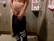 Russian guy shows his cock and pisses on the floor in the public toilet of the hostel