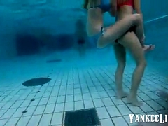 girsl underwater at pool