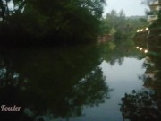 Girl Peeing in darkness into tropical river after sunset - Angel Fowler