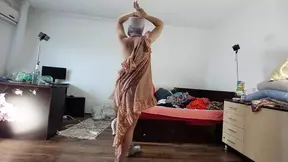 Sexy mom has fun trying on clothes and cutting them
